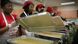 Pre-culinary academy students serving food
